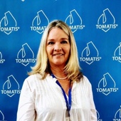 An image of Jennifer Muller wearing a white shirt with a blue lanyard in front of a blue background