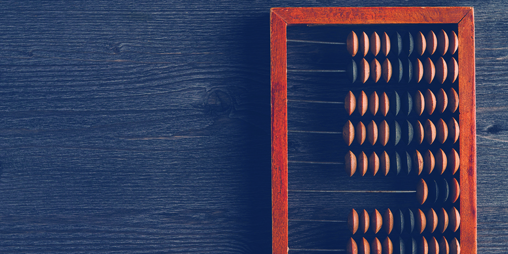 An image of an abacus on top of a wooden desk