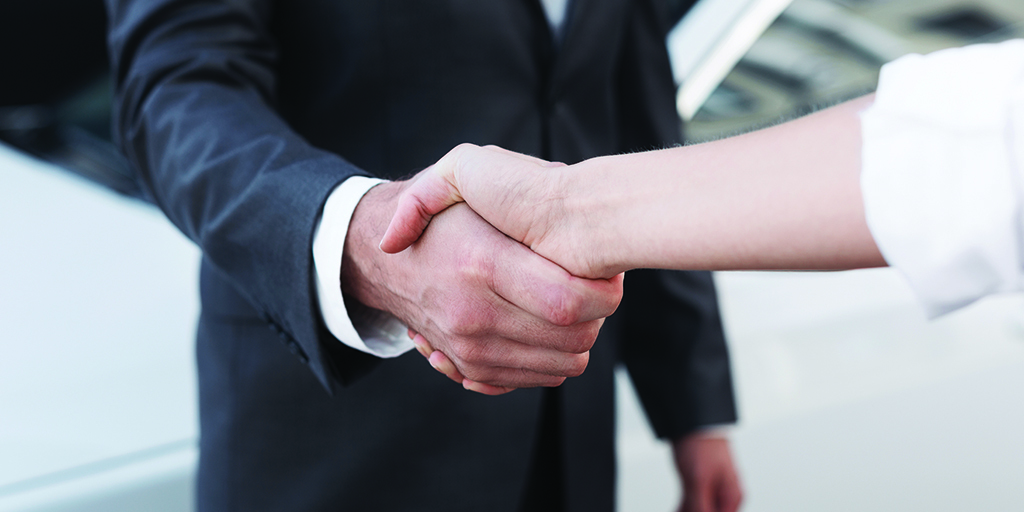 An image of two people in business attire shaking hands