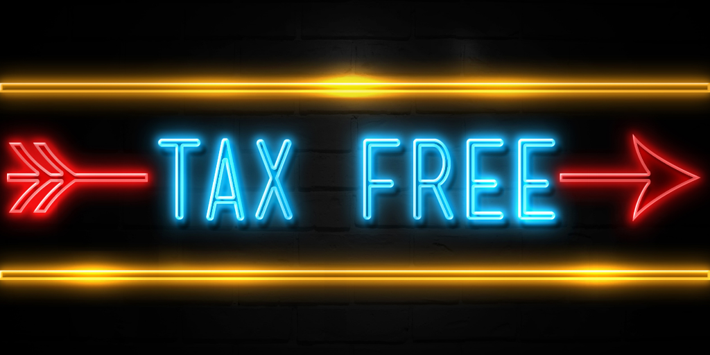 An image of a neon sign that says "Tax Free" in blue with a red arrow in front of a black background